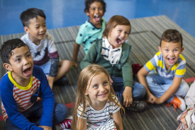 kindergarten students sitting on the floor