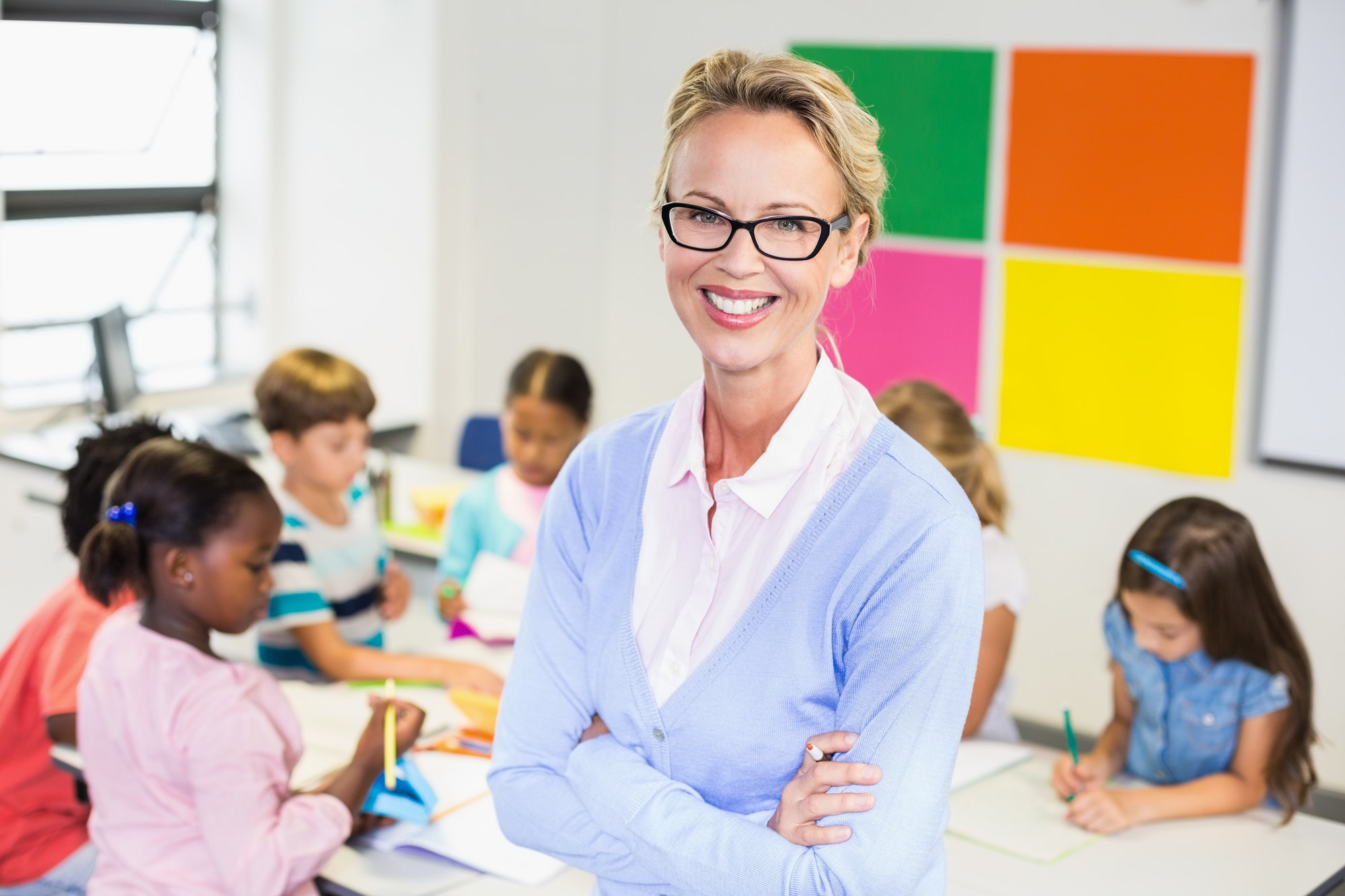 portrait of teacher standing in classroom
